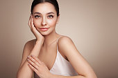 istock Portrait beautiful young woman with clean fresh skin 1329622588