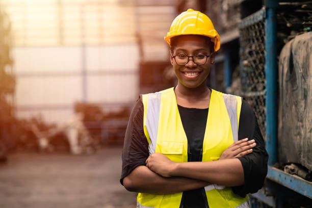 Portrait Black smart African women worker standing happy smiling in factory industry workplace stock photo