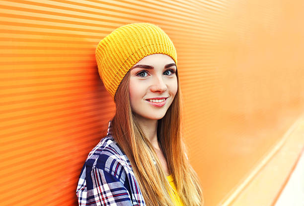 portrait closeup beautiful young girl in yellow hat over colorful - portrait girl stockfoto's en -beelden