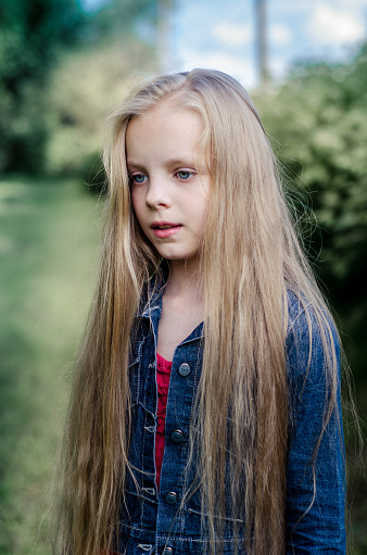 Portrait Of A Beautiful Blonde Little Girl With Long Hair