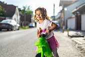 Portrait of a smiling beautiful girl looking at camera and riding a motorcycle.