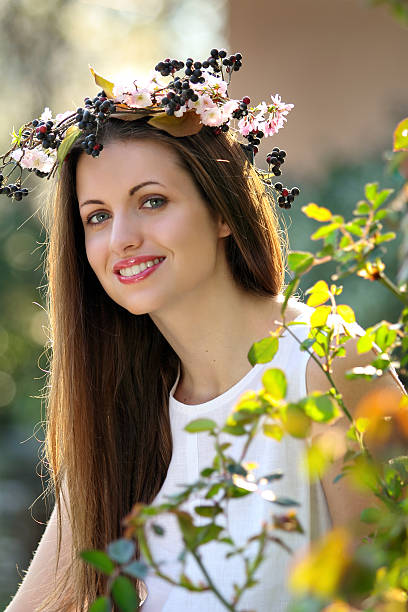 Portrait of a beautiful smiling girl with flower crown stock photo