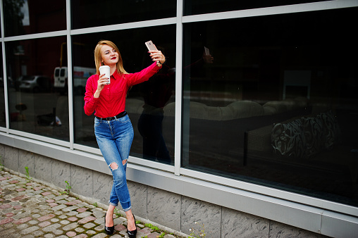Portrait Of A Beautiful Woman In Red Blouse And Casual Jeans