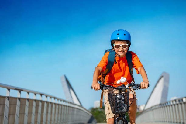 Portrait of a boy on the bicycle cycle over bridge stock photo