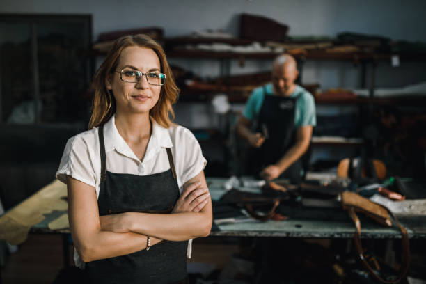 Portrait of a female business owner in the leather accessories design studio stock photo