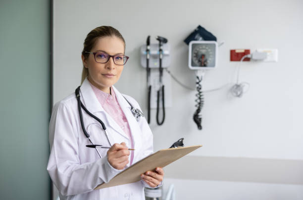 Portrait of a female doctor working at her office stock photo