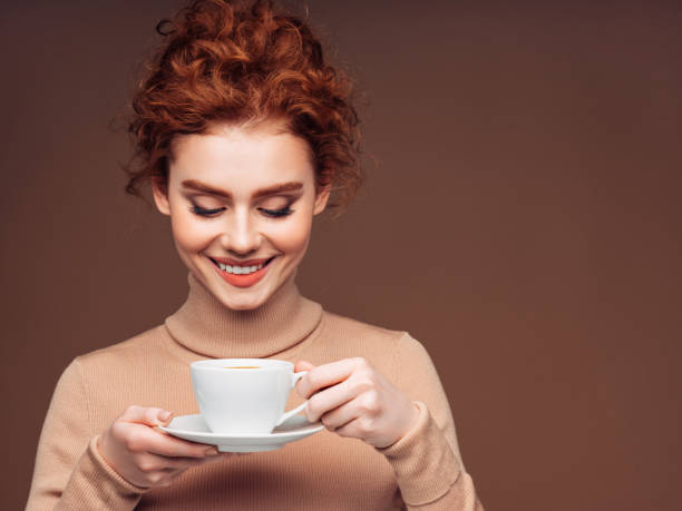 Portrait of a fresh and lovely woman, holding a cup of coffee stock photo