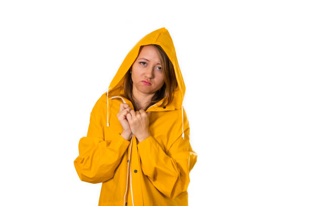 Portrait of a girl in a yellow raincoat. Isolate on white background stock photo
