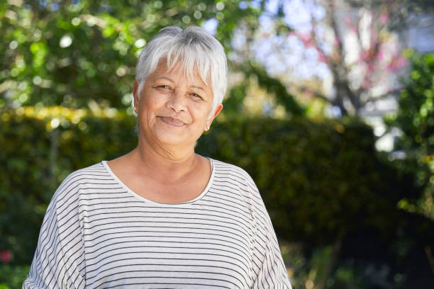 Portrait of a happy and confident senior woman Portrait of a happy and confident senior woman standing in the garden mature women stock pictures, royalty-free photos & images
