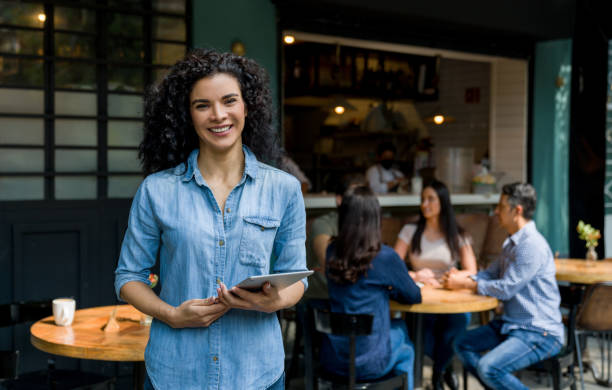 Portrait of a happy business owner of an outdoor restaurant smiling stock photo