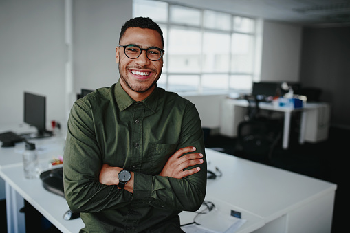 Portrait Of A Happy Confident Young African American Businessman Standing  With His Arms Crossed Looking At Camera Stock Photo - Download Image Now -  iStock