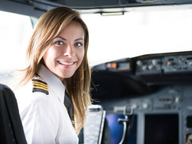 Portrait of a happy pilot in the airplane's cockpit Portrait of a happy pilot in the airplane's cockpit looking at the camera smiling before take off - travel concepts pilot stock pictures, royalty-free photos & images