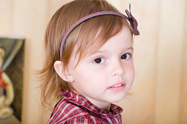 Portrait of a little girl with bow knot on head stock photo