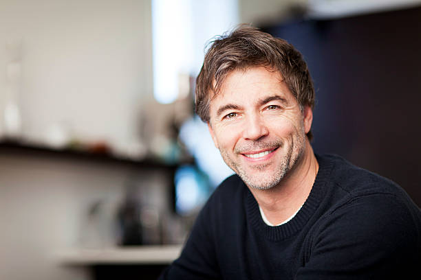 Portrait Of A Mature Man Smiling At The Camera. Home stock photo