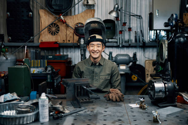 Portrait of a mid adult male in his metal fabrication workshop stock photo