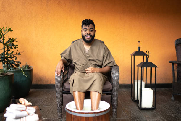 Portrait of a mid adult man doing a foot treatment at a spa Portrait of a mid adult man doing a foot treatment at a spa man pedicure stock pictures, royalty-free photos & images