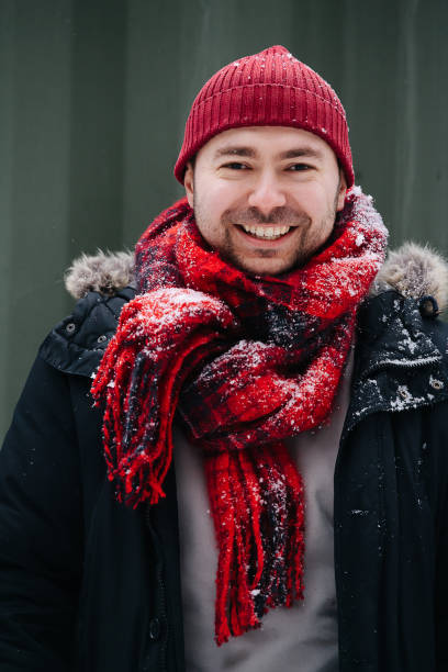 Portrait of a positive middle age man in snowy winter clothes stock photo