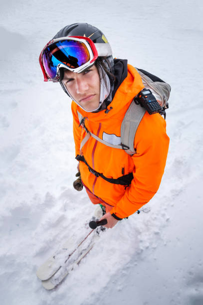 portret van een professionele jonge skiër in een bivakmutsmasker en een rugzak op ski's. het concept van de wintersport - posing with ski stockfoto's en -beelden