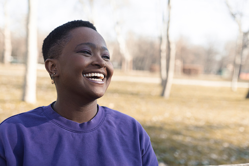 Portrait of a smiling African American young woman enjoying outdoors