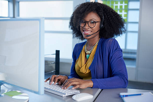 Portrait of a smiling customer service representative with an afro stock photo