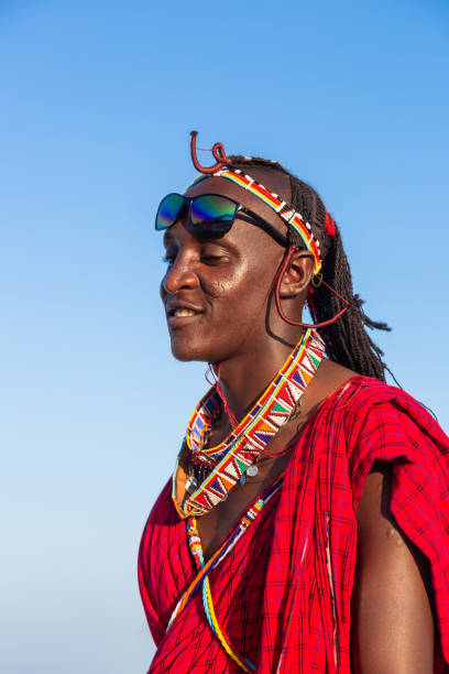 portrait of a smiling masai Diani Beach, Kenya, 12.02.2016: portrait of a smiling masai in traditional clothing, side view maasai warrior stock pictures, royalty-free photos & images
