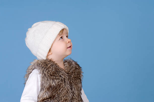 portrait of a toddler with knitted white stock photo