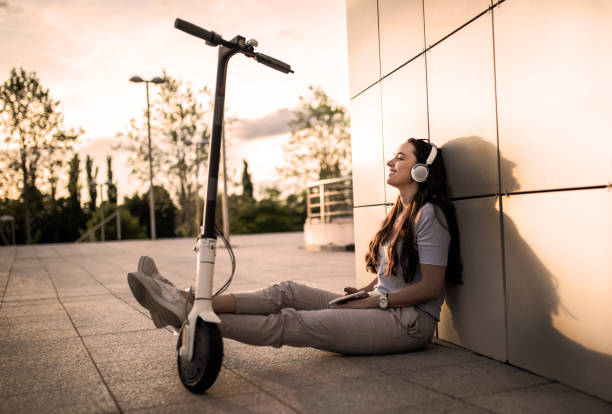 Portrait of a woman with electric scooter stock photo