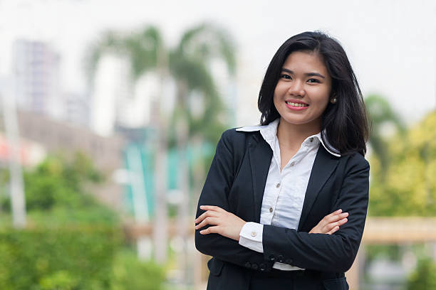 Portrait of a young businesswoman Portrait of a young confident businesswoman outdoors in an urban park environment. filipino woman stock pictures, royalty-free photos & images