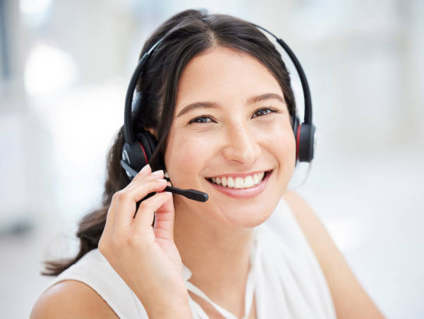 Portrait of a young call centre agent working in an office Of course I can help! call center photos stock pictures, royalty-free photos & images