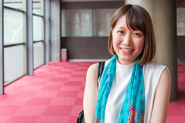 Portrait of a Young Japanese Business Woman Portrait of a young Japanese business woman in a corporate office building in Kyoto Japan shy japanese woman stock pictures, royalty-free photos & images