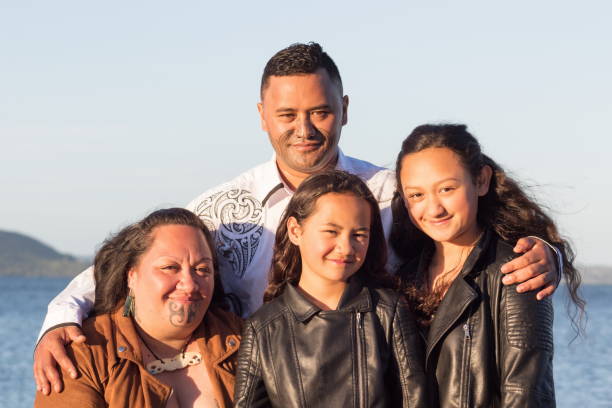 Portrait of a young Maori family taken outdoors stock photo