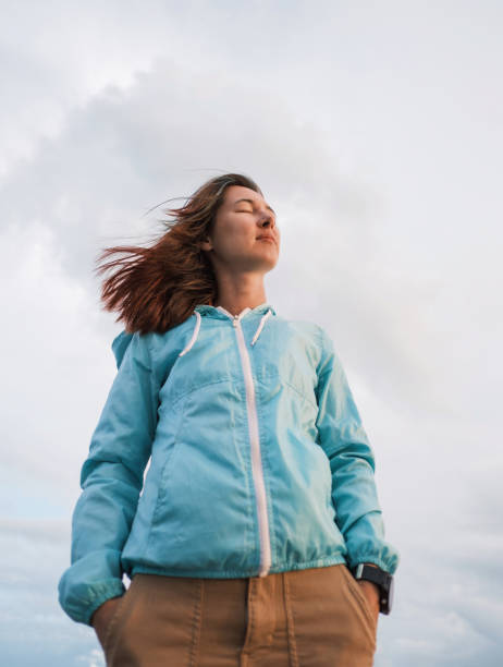Portrait of a young woman in a blue windbreaker. stock photo