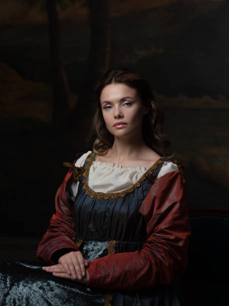 Portrait of a young woman in the style of a Renaissance painting. Portrait of a young woman in the style of a Renaissance painting. Beautiful mysterious girl in medieval dress renaissance stock pictures, royalty-free photos & images