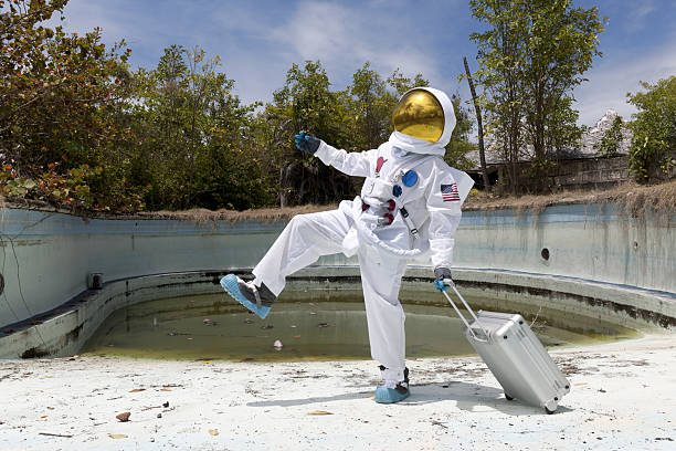 Portrait of an astronaut in empty swimming pool. stock photo