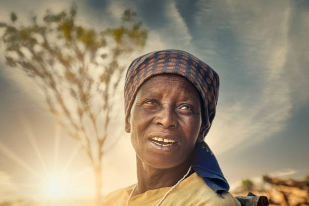 portrait of an old African woman at sunset stock photo