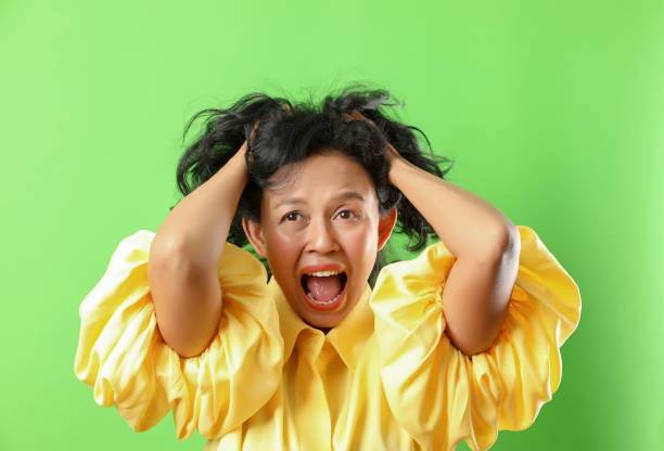 Portrait of angry crazy woman isolated on green screen background. stock photo