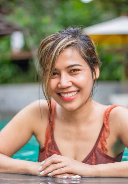 Portrait of Asian women wear swimsuits Background   swimming pool stock photo