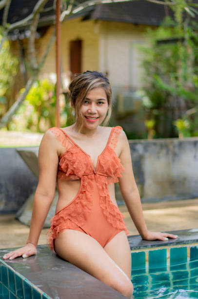 Portrait of Asian women wear swimsuits Background swimming pool stock photo