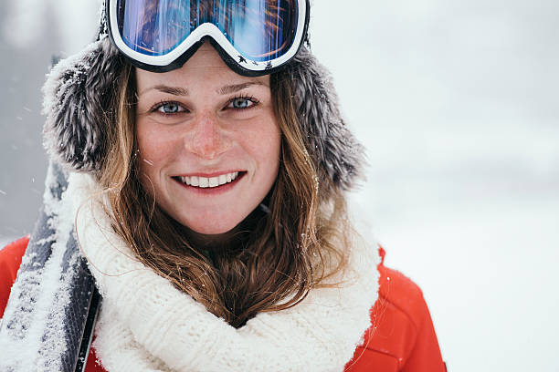 portrait of attractive skier - posing with ski stockfoto's en -beelden
