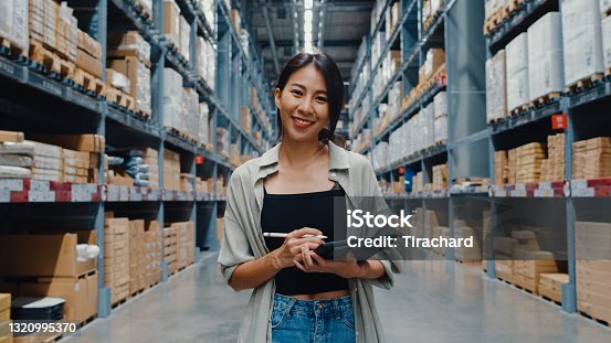 istock Portrait of attractive young Asia businesswoman manager smiling charmingly looking at camera hold digital tablet stand in retail shopping center. 1320995370