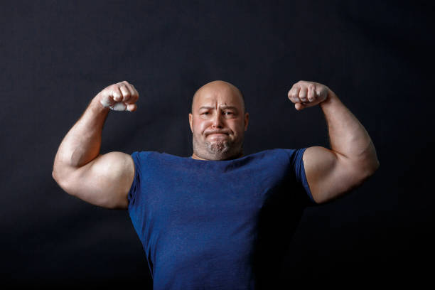 A portrait of bald strongman in dark t-shirt stock photo