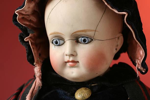 Portrait of beautiful antique German bisque doll. Antique German doll with blue glass eyes, from 1885. Doll is broken but is waring   broken doll 1 stock pictures, royalty-free photos & images