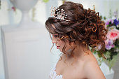Portrait of a beautiful girl in a wedding dress. Bride in luxurious dress, close-up