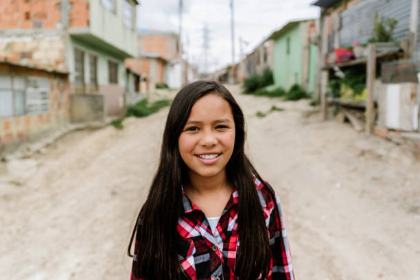 Portrait of beautiful girl in shanty town. Portrait of beautiful girl in shanty town. Poor infant concept colombian ethnicity stock pictures, royalty-free photos & images