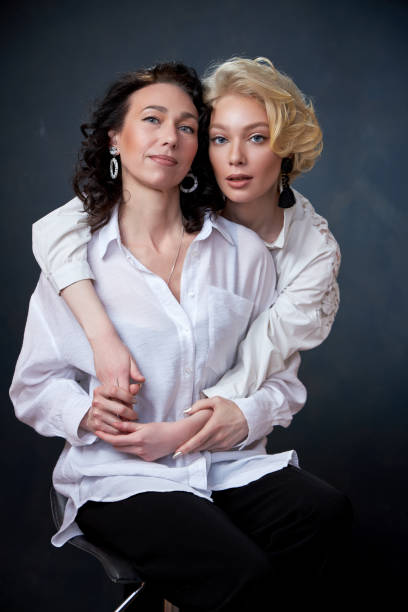 Portrait of beautiful mother daughter possing in a studio stock photo