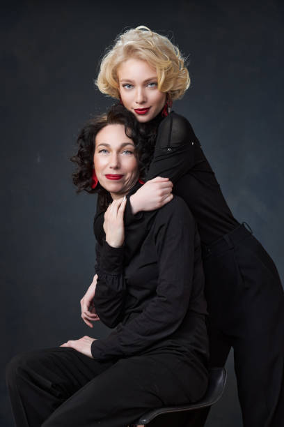 Portrait of beautiful mother daughter possing in a studio stock photo