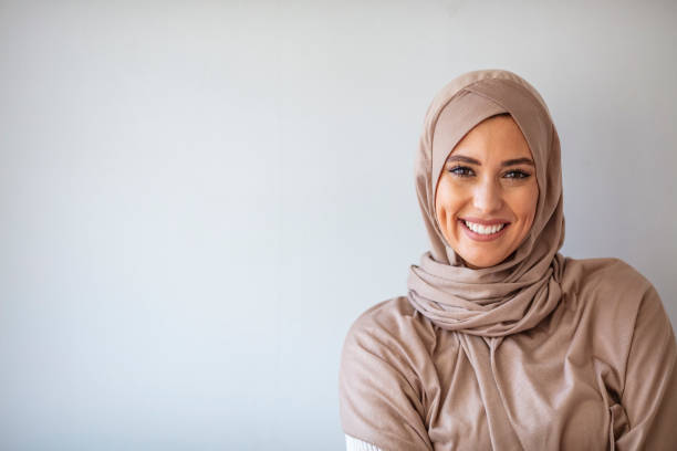 Portrait of beautiful Muslim woman on grey background. Portrait of pretty young asian muslim woman in head scarf smile. Portrait closeup of muslim prayer woman 20s in hijab smiling isolated over gray background. beautiful arab woman stock pictures, royalty-free photos & images