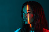 istock Portrait of beautiful woman lit by neon colored lights 1313668225