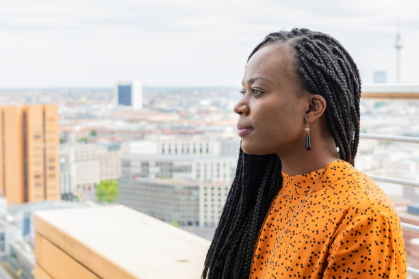 portrait of black business woman at rooftop in berlin stock photo