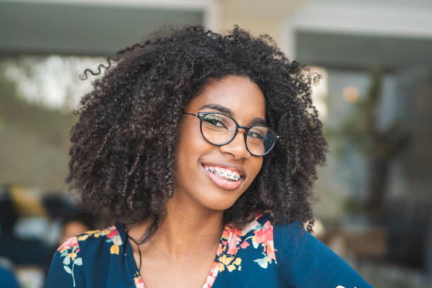 Portrait of brazilian afro woman wearing glasses Human Face, Happiness, Females, Brazil, Young Women dental braces photos stock pictures, royalty-free photos & images